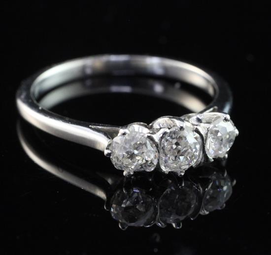 A platinum and three stone diamond ring, size L.